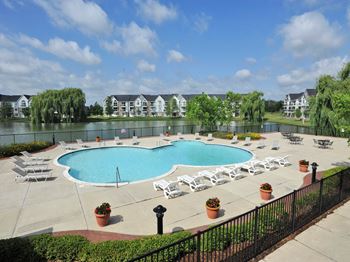 Expansive outdoor swimming pool with large sundeck and lake views